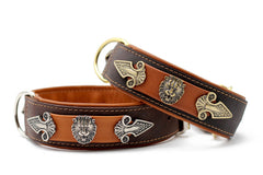 Braune und orange Hunde-Halsbänder aus Leder mit Löwenkopf-Elementen und dekorativen Verzierungen.