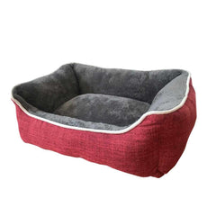 Rotes Hundebett "ARNO" mit grauer, weicher Innenfläche und erhobenem Rand in dekorativem Design.
