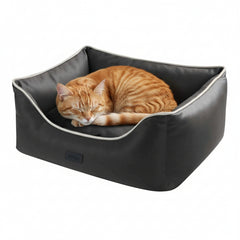 Schwarzes Katzenbett "HORIA" mit hoher Rückenlehne, darin schläft eine orangefarbene Katze gemütlich zusammengerollt.