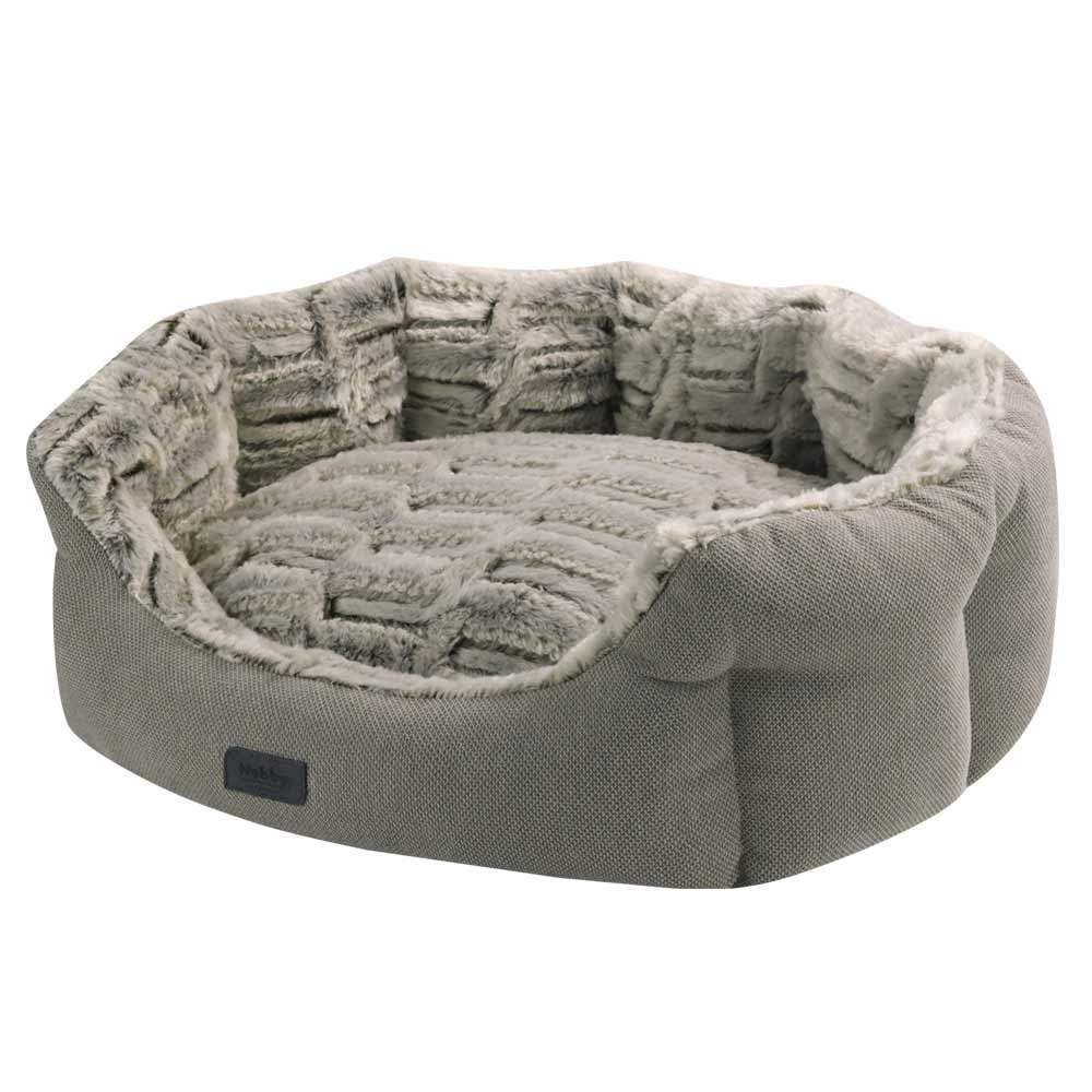 "Komfortbett oval 'CACHO' für Hunde mit flauschiger Innenauskleidung in Grau und strukturierter Außenhülle."
