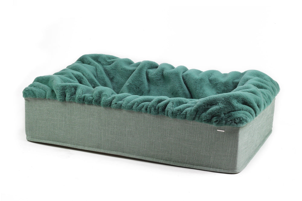 Hundebett Buddelbox® in rechteckiger Form aus grauem Stoff mit plüschigem Innenmaterial in Blaugrün.