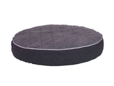 Rundes orthopädisches Kissen "OSSO" für Hunde mit samtigem Bezug und gestepptem Design in elegantem Dunkel.