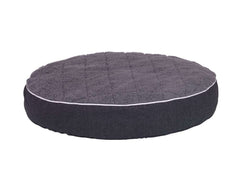Rundes orthopädisches Kissen "OSSO" für Hunde mit samtigem Bezug und gestepptem Design in elegantem Dunkel.