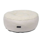 Rundes, beiges Hundebett "Kamba" mit flauschigem Oberteil und Rippstruktur für maximalen Komfort.