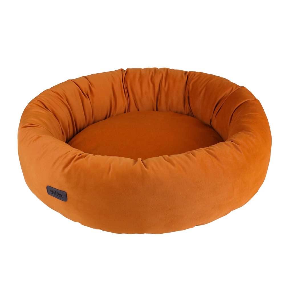 Rundes orangefarbenes Hundebett "Cumba" mit hohem Rand und weichem Innenbereich für optimalen Komfort.