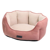 Komfortables ovales Kuschelbett „Majid“ für Hunde in weichem Beige und sanftem Rosa, ideal zum Entspannen.