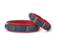 Zwei farbenfrohe Hundehalsbänder in Blau und Rot mit maritimen Motiven wie Segelschiff und Steuerrad.