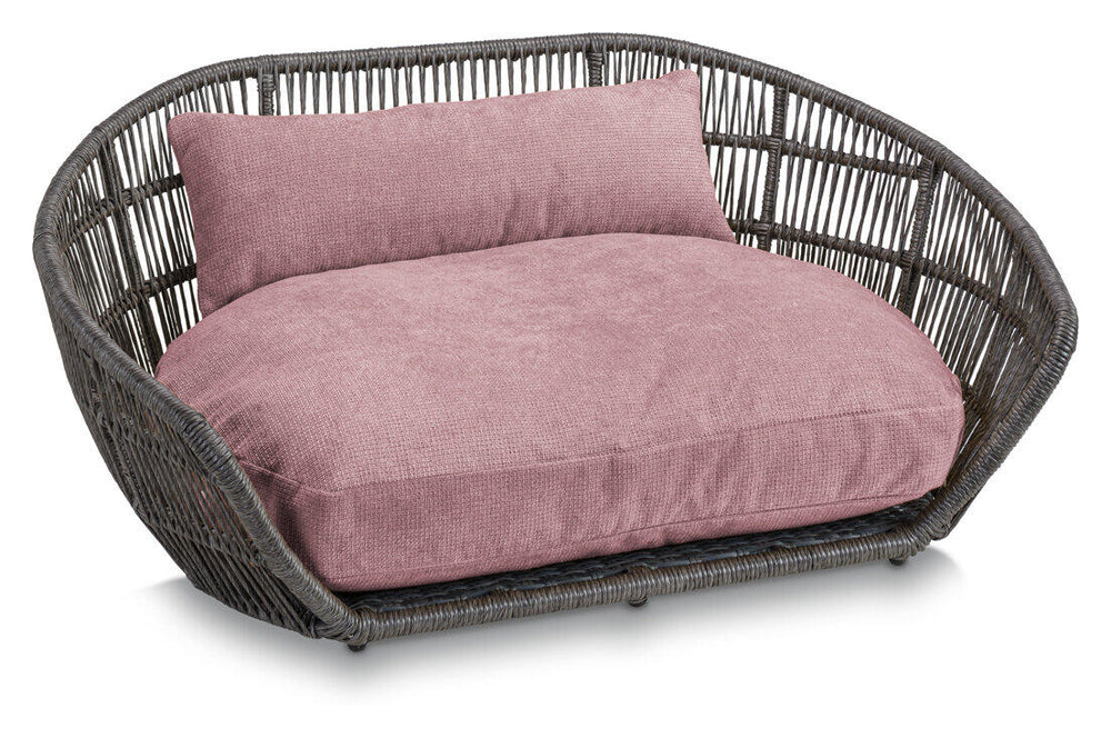 Modernes ovales Hundebett TUDOR in Dunkel mit hoher Umrandung und zartem rosa Kissen für Hunde.