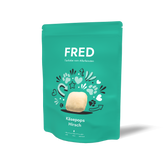 Grüne Verpackung von FRED Käsepops Hirsch mit bunten Symbolen und kreativem Design.