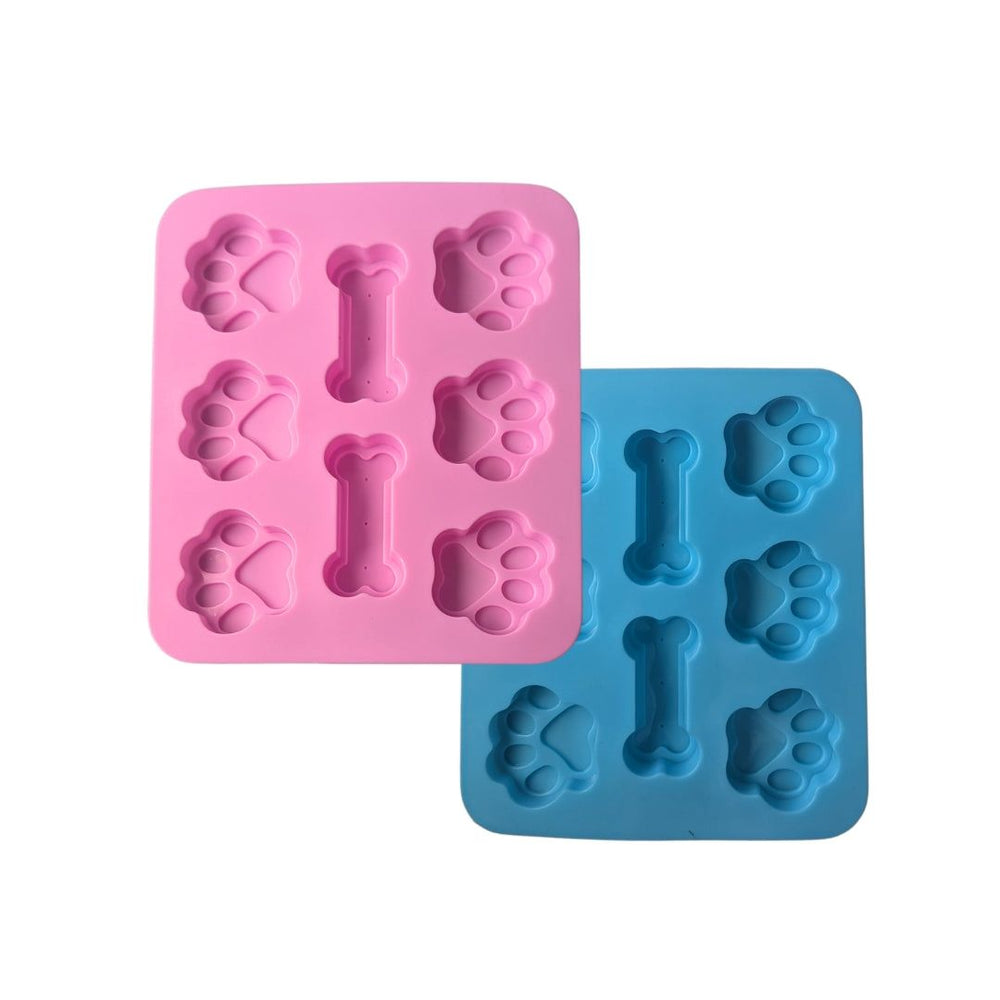 Eiswürfelformen aus Silikon in Pink und Hellblau mit Hundepfoten- und Knochenformen für Backen und Desserts.