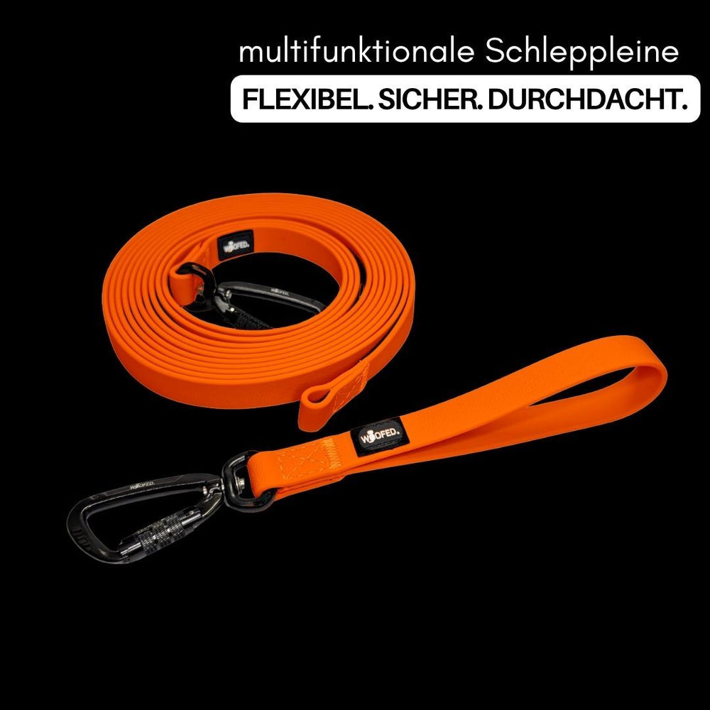 Multifunktionale WOOFLEX® Schleppleine in leuchtendem Orange mit stabilem Karabiner und komfortablem Griff.