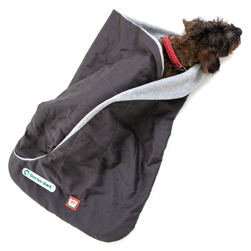 Hunde-Schlafsack von Doctor Bark in Grau, mit gestepptem Design und einem eingewickelten Hund darin.