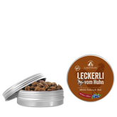 Runde Dose mit "Leckerli vom Huhn" von Lakefields, gefüllt mit braunen Snacks auf hellem Hintergrund.