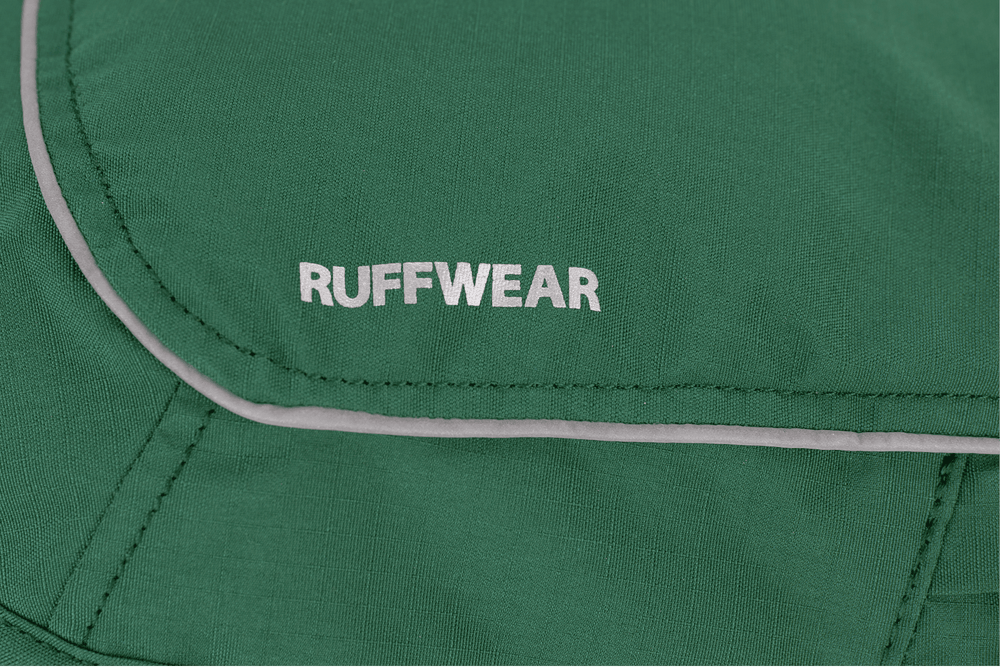 "Grüne Overcoat Fuse™ Hundejacke mit RUFFWEAR-Logo und reflektierenden Nähten für Sicherheit im Freien."