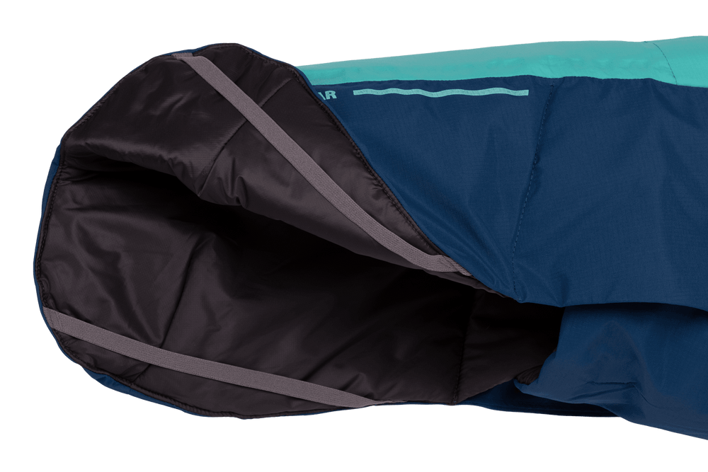 Innenansicht des Ärmel der blauen Vert™ Jacke mit türkisfarbener Oberkante und glattem, grauem Innenstoff.