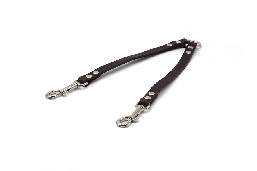Zweigeteilter Hundegeschirrverbinder aus braunem Leder mit metallenen Karabinerhaken und silbernen Nieten, ideal für zwei Hunde.