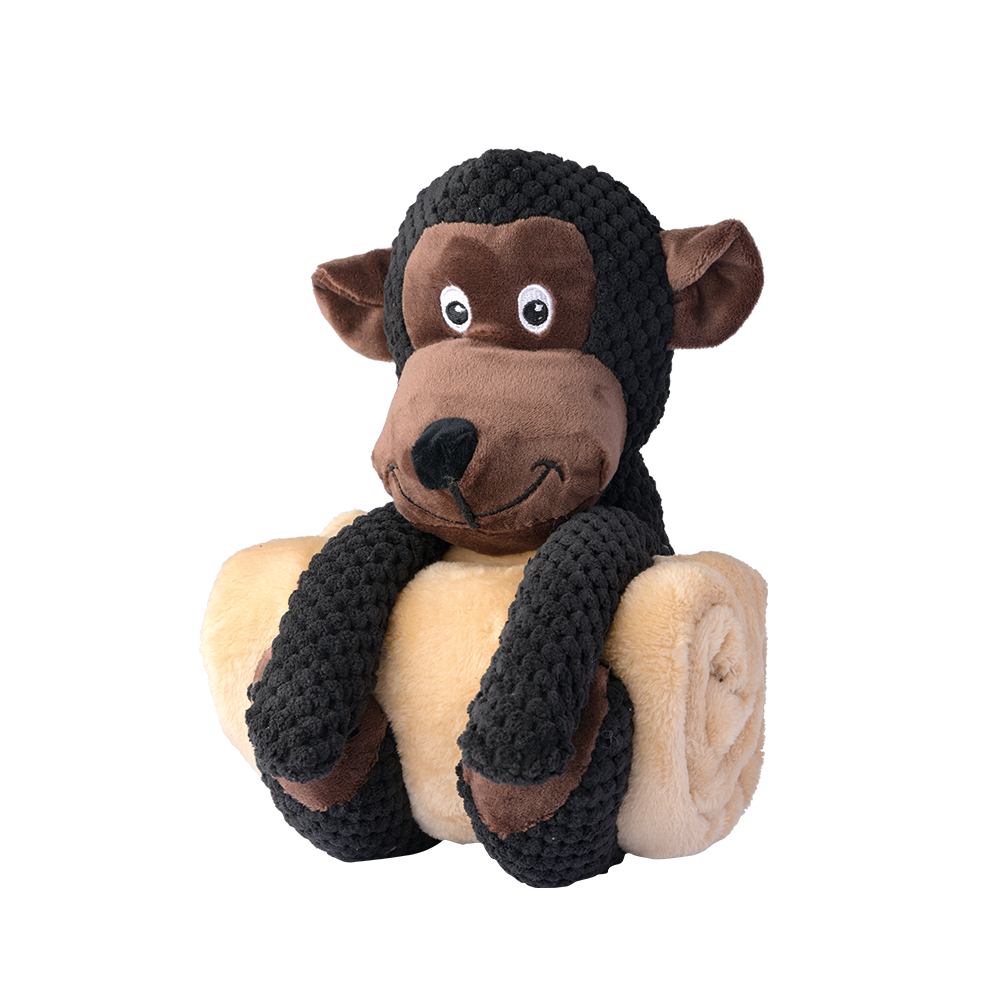 Kuscheltier-Affe mit strahlend großen Augen sitzt auf heller Decke und bringt Freude ins Kinderzimmer.