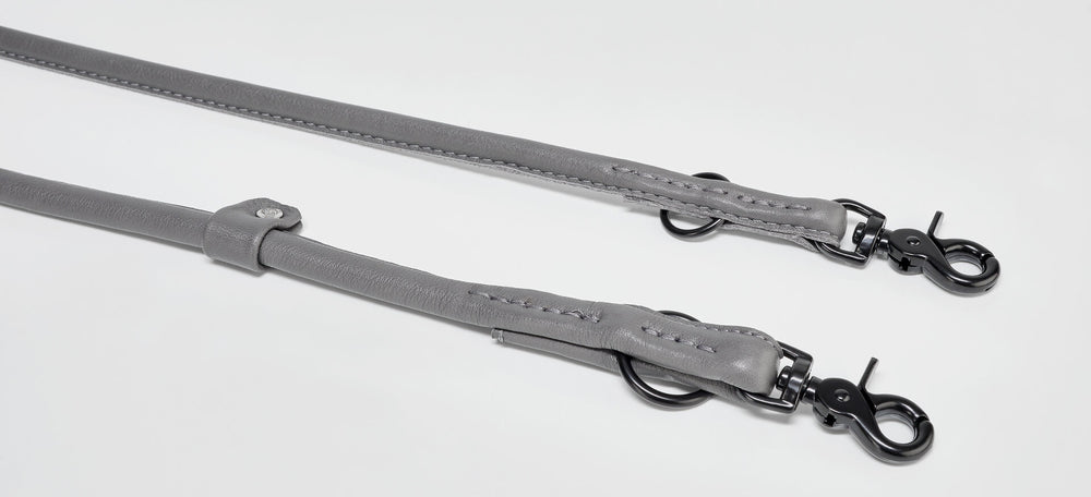 Stylisches graues Leder-Hundehalsband mit Metallkarabinern und zwei Befestigungsclips für ein modisches Statement.