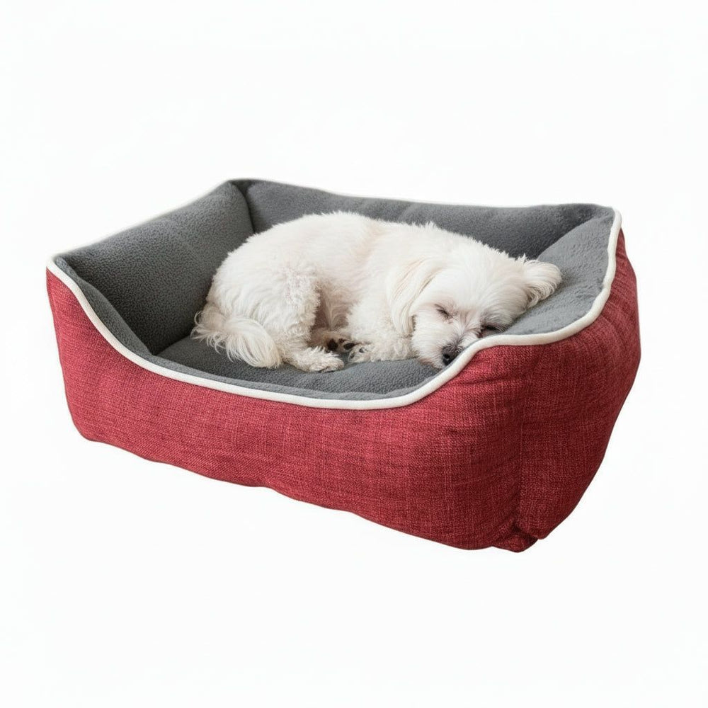 Hundefreundliches Schlafbett "ARNO" in Rot und Grau mit erhöhtem Rand, ideal für gemütliche Nächte, kleiner Hund schläft.