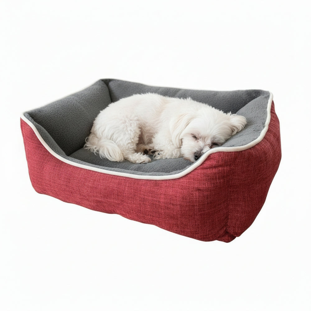 Hundefreundliches Schlafbett "ARNO" in Rot und Grau mit erhöhtem Rand, ideal für gemütliche Nächte, kleiner Hund schläft.