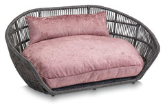 Modernes ovales Hundebett ALLURE mit geflochtenem grauem Material und rosa gepolstertem Kissen für optimalen Komfort.