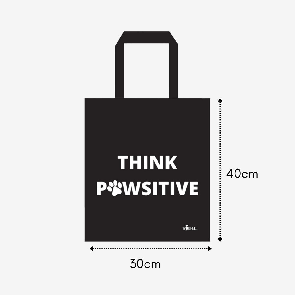 Baumwolltasche "Think Pawsitive" in Schwarz mit weißem Schriftzug und Pfotenmotiv, ideal für Hundeliebhaber und umweltfreundl