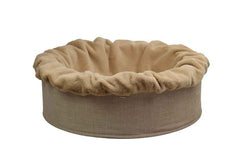 Rundes, beiges Hundebett Buddelnest® mit weichem Stoffbezug und knuddeligem Rand für optimalen Komfort.