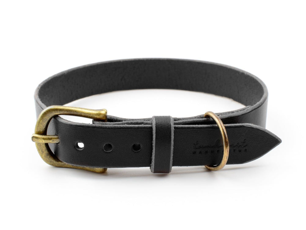 Schwarzes Lederhalsband WALDSTREUNER mit messingfarbener Schnalle und „tamelia“-Schriftzug, schlicht und elegant.