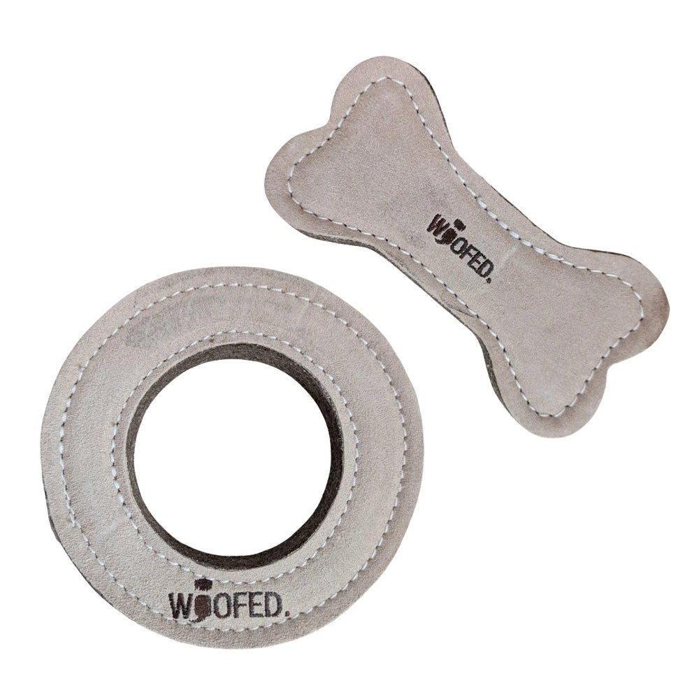 Natürliches Hundespielzeug im Set: runder Ring und knochenförmiges Spielzeug in hellgrauer, weicher Velours-Optik.