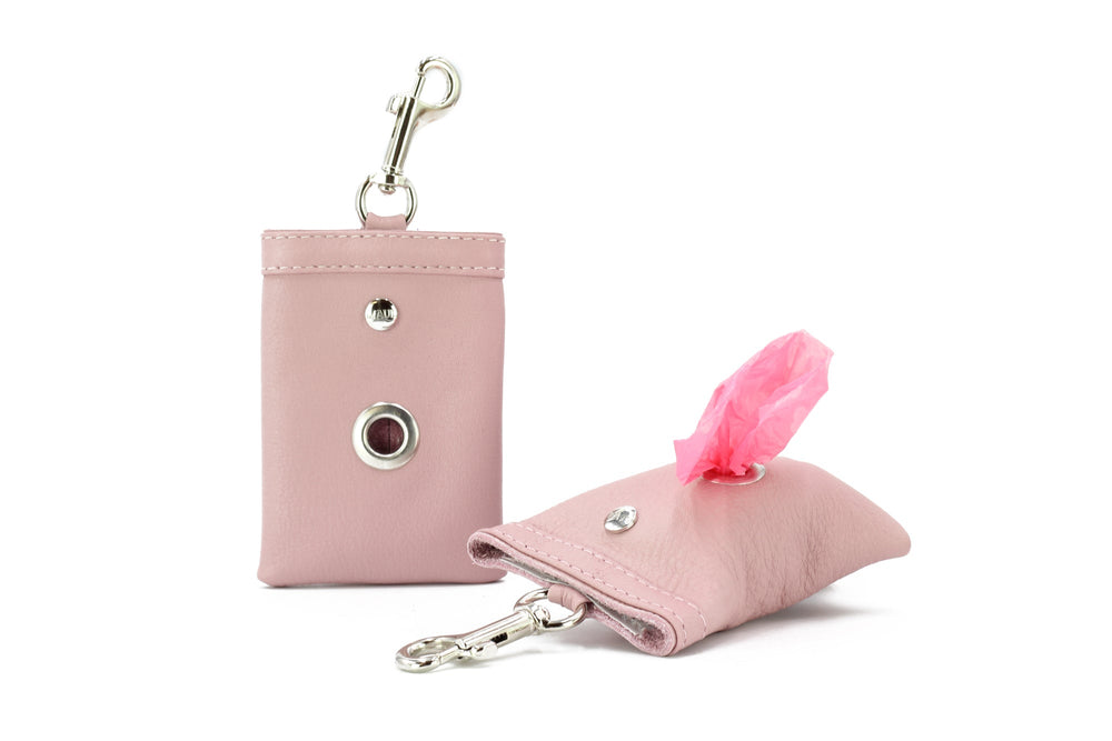 Rosa Hundekotbeutelspender aus Leder mit Karabinerhaken zur praktischen Befestigung an Leine oder Tasche.