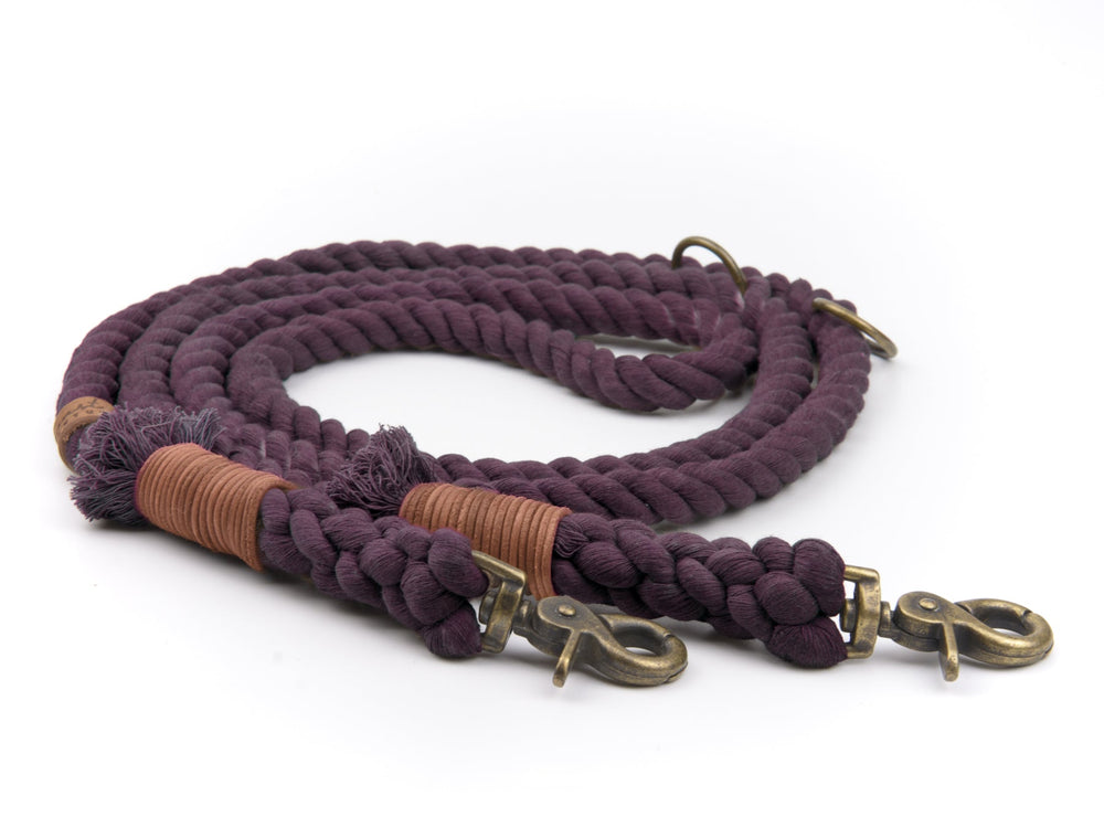 Dicke lila Tauleine mit brassfarbenen Karabinerhaken und geflochtener Struktur, in der Mitte braun umwickelt.