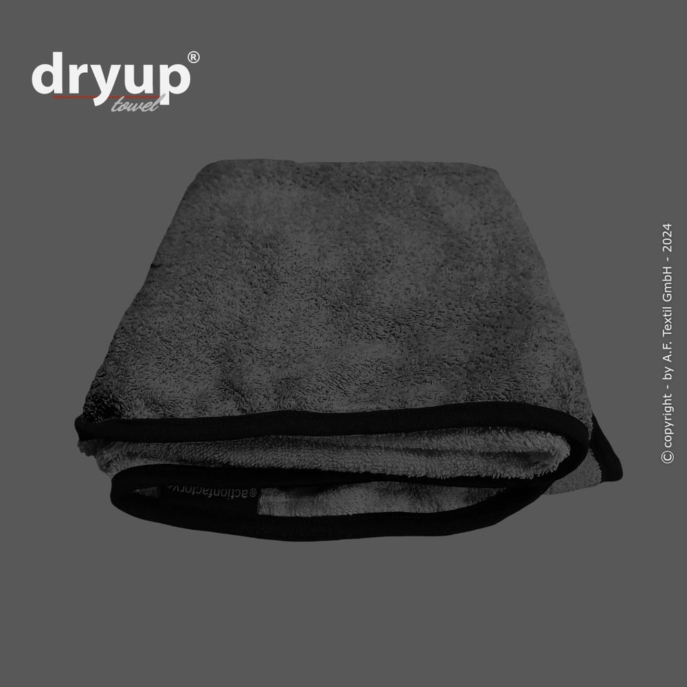 Graues Dryup® Handtuch mit schwarzem Rand und modernem Logo, entwickelt aus weichem Material für optimalen Komfort.