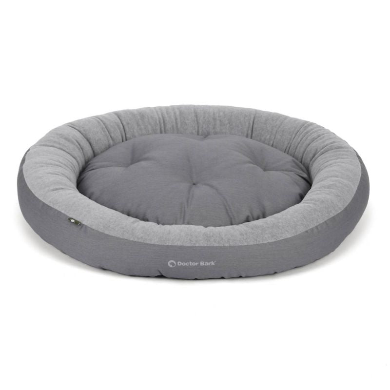 Rundes Hundebett in Grautönen, weich gepolstert und bequem, ideal für eine gemütliche Auszeit für Ihren Hund.