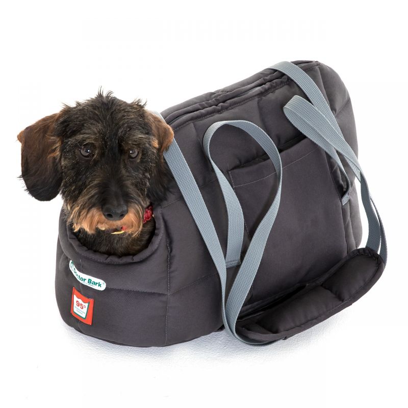 Graue Hundetasche mit abnehmbarem Schulterriemen und einem kleinen Hund, der neugierig aus der Öffnung schaut.
