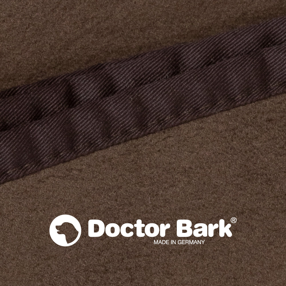 Braune Fleece Kuscheldecke von Doctor Bark mit dunkler Naht und "MADE IN GERMANY" Logo. Gemütlich und hochwertig.