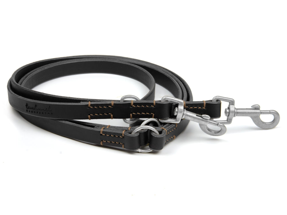 Schwarze Lederleine mit robustem Design und hellbrauner Naht, ideal für Hunde, mit stabilen Karabinern.