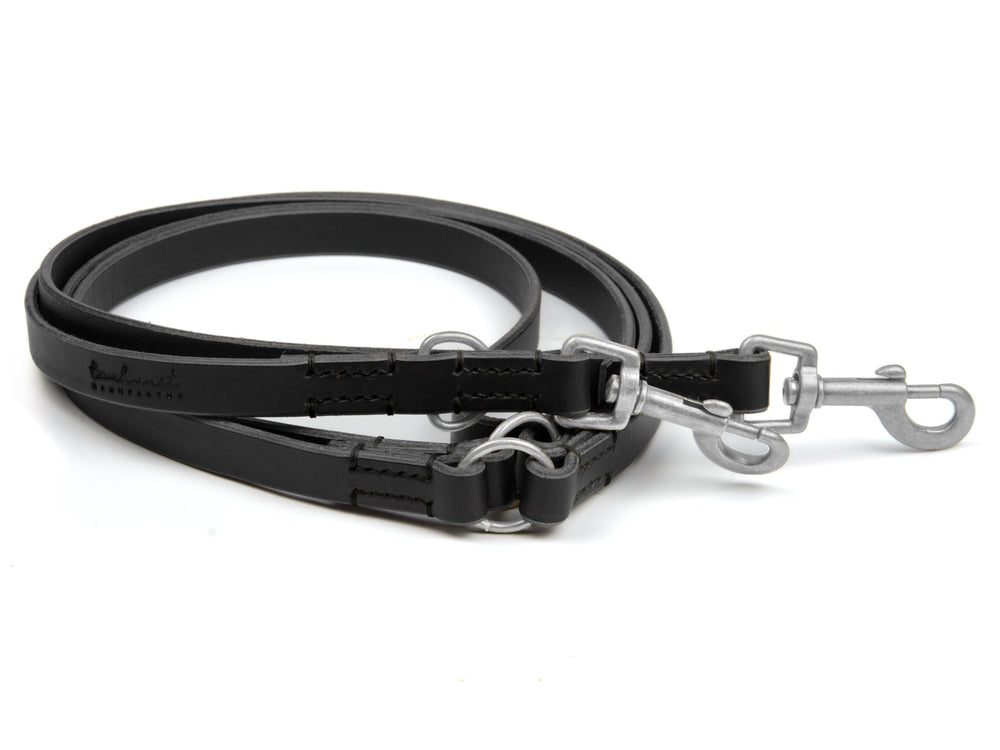 Schwarze Lederhundeleine Waldgeist mit verstellbaren Haken und Metallringen für optimale Flexibilität und Komfort.