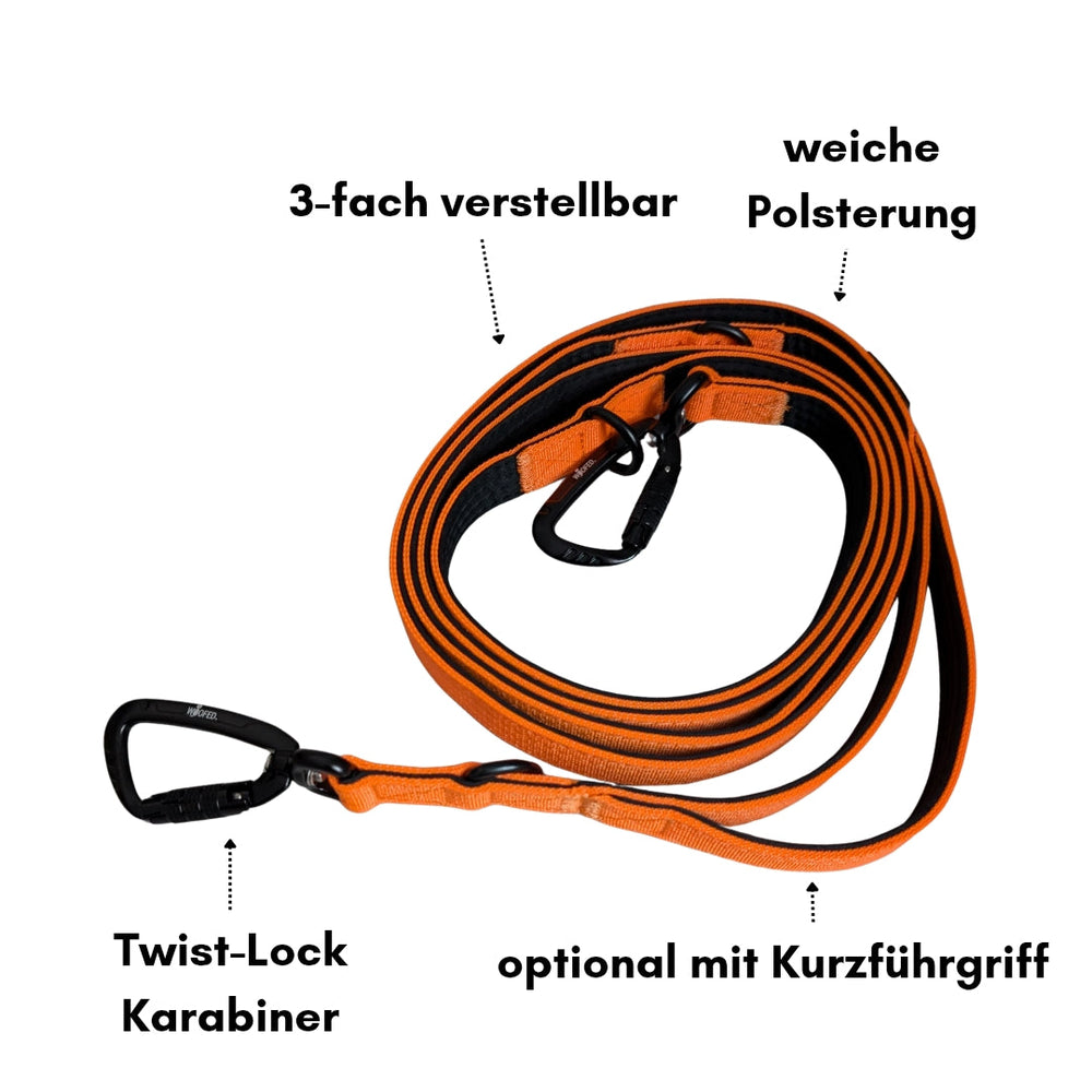 Verstellbare orange-schwarze Hundeleine aus Nylon mit Polsterung und Sicherheitskarabinern. Ideal für Spaziergänge.