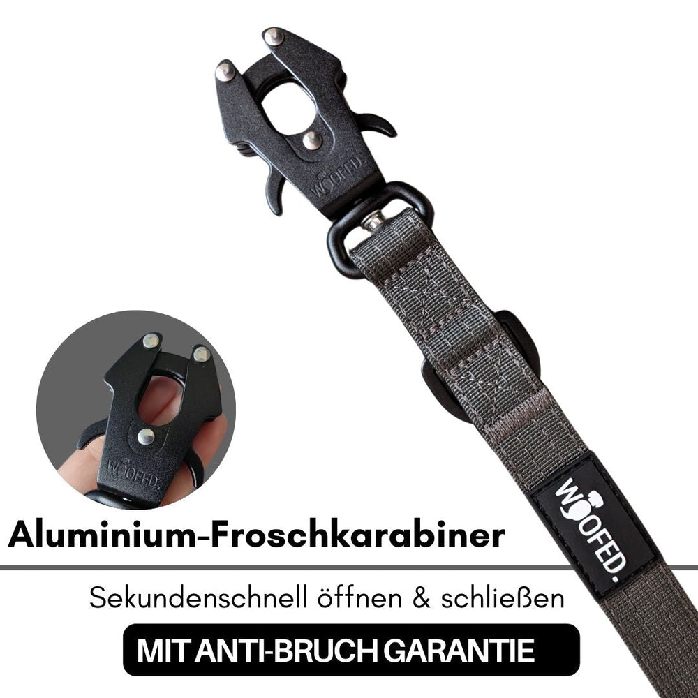 Aluminium-Froschkarabiner mit schwarzer Oberfläche und grauem Gurt für sichere Anwendungen.