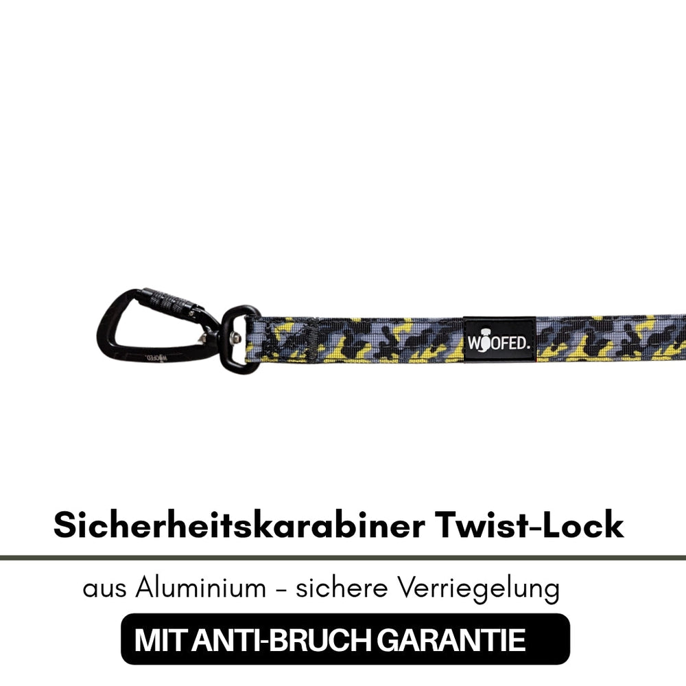 Sicherheitskarabiner aus Aluminium mit Twist-Lock, gelb-schwarzes Camo-Design für Führleinen und Outdoor-Aktivitäten.
