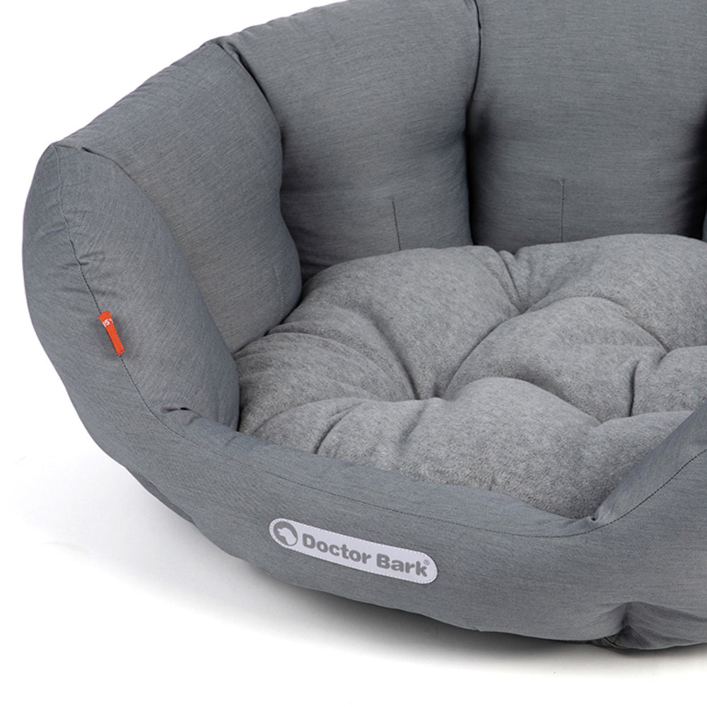 Rundes, graues Hundebett von Doctor Bark mit weicher Polsterung und hohen Seitenrändern, ideal für Komfort und Entspannung.