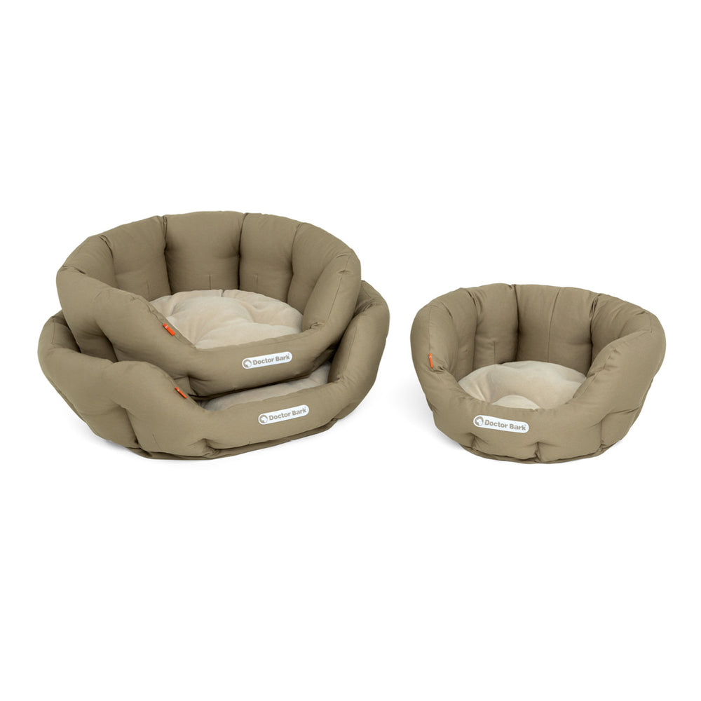 Beige Hundebetten von Doctor Bark: runde Form mit hohen Kanten, ideal für gemütliches Liegen und Entspannen.