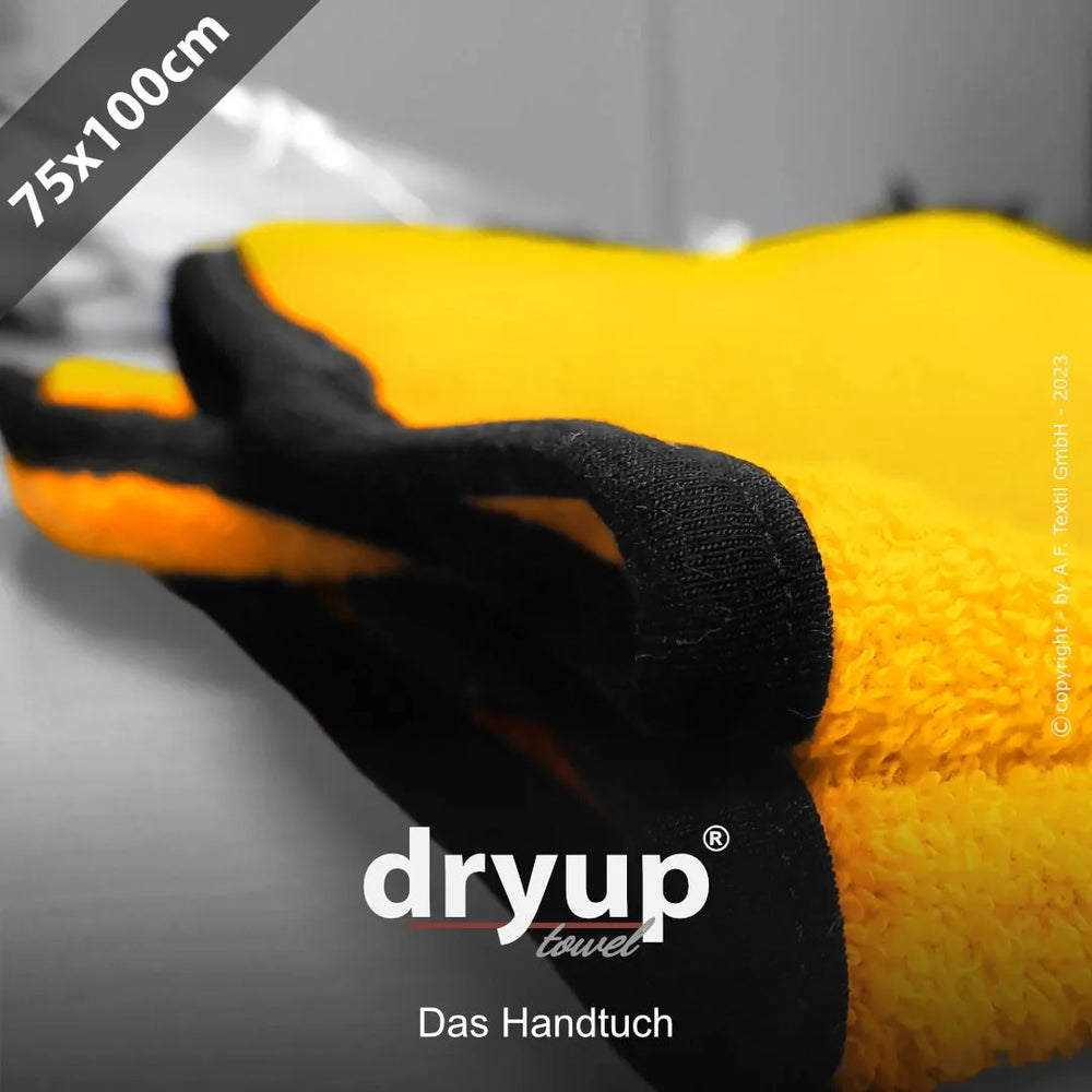 Gelbes, flauschiges Dryup® Handtuch mit schwarzer Umrandung, misst 75 x 100 cm. Ideal für Zuhause oder unterwegs.
