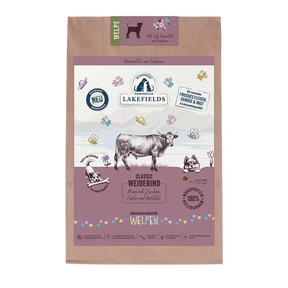Trockenfutter für Welpen mit Rind von Lakefields, verpackt in einer braunen Tüte mit bunten Hundeillustrationen.